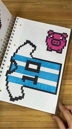 an open notebook with some pixel art on it