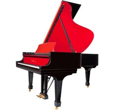 a red and black piano sitting on top of a table