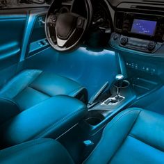 the interior of a car with blue leather seats and dash board, including steering wheel