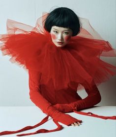 a woman in red is sitting on the floor