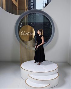 a woman standing in front of a round window with the word'center'on it