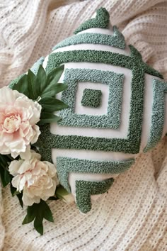 there is a green and white cake with flowers on it