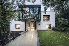 this modern house is surrounded by trees and grass