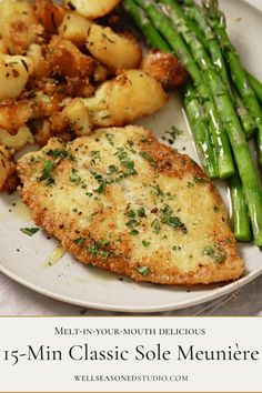 a white plate topped with chicken, potatoes and asparagus next to green beans