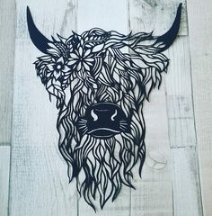 the head of a bull with long horns and flowers on it's face is made out of wood planks