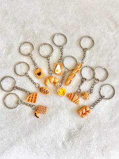 a bunch of key chains that have different types of items attached to them on a white surface