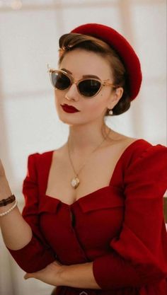 a woman wearing sunglasses and a red dress