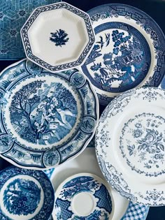 several blue and white plates stacked on top of each other