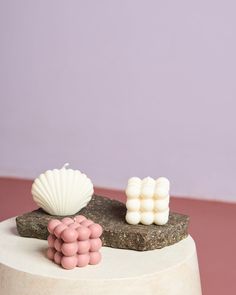 there is a cake that has pink and white decorations on it, along with seashells