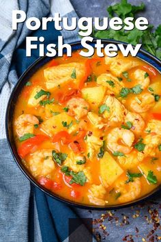 a bowl filled with shrimp and potatoes next to cilantro leaves on top of a table