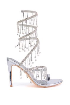 The AZALEA WANG Elke Silver Coil Diamond Drip Sandal is a metallic faux patent leather style that features an open almond toe silhouette, a Comfort Cushion insole, a slim stiletto heel, a slim toe band, and a textured outsole. Complete with a spiral shaft that wraps around the ankle, adorned with opulent rhinestone fringe detailing.   (all measurements are approximate from size 7.5) - Faux Patent Leather Upper - Open Almond Toe - Comfort Cushion Insole - Stiletto Heel - 6.5” Shaft Height - 4” Heel Height - Imported  Product ID: 395375 Water Fashion, Wrap Around Heels, Fancy Heels, Azalea Wang, Wedding Heels, Silver Heels, Leather Style, Stiletto Heel, Leather Fashion