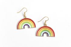 "These sweet rainbow earrings can't wait to spruce up your festival outfit with some serious retro-boho charm! Earring hooks are hypoallergenic. ▲ Rainbow charms measure approx. 1\" x 1 1/8\" ▲ Gold-plated surgical steel earring hooks (hypoallergenic) We try to display product colors as close to life as possible. However, all computer monitors are different and so there might be slight color variations from screen to screen. If you have any questions, feel free to contact us! CARE INSTRUCTIONS J Cute Multicolor Dangle Jewelry, Adjustable Rainbow Earrings As Gift, Trendy Rainbow Dangle Jewelry, Fun Rainbow Hypoallergenic Jewelry, Cute Multicolor Jewelry With Ear Wire, Cute Multicolor Jewelry, Everyday Rainbow Jewelry For Summer, Everyday Summer Rainbow Jewelry, Summer Everyday Rainbow Jewelry