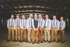 a group of young men standing next to each other in front of a building and wearing ties