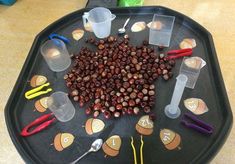 a black tray topped with lots of different types of items on top of a table