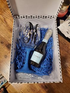 a wine bottle and some scissors in a box