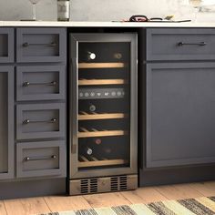 a wine cooler sitting in the middle of a kitchen