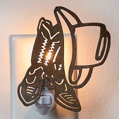 a light that is on the side of a wall with a cat design on it