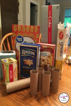 an assortment of food items sitting on a wooden table in front of boxes and packages