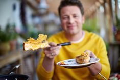 a man holding a plate with some food on it