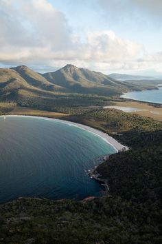 an aerial view of the ocean and mountains