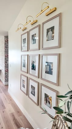 a living room filled with furniture and pictures on the wall