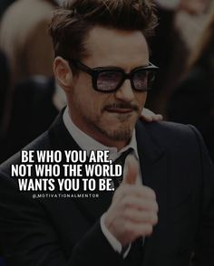 a man in a suit and sunglasses pointing to the side with a quote on it