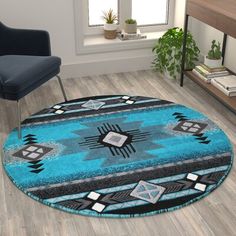 a blue area rug with black and white designs on the floor next to a chair