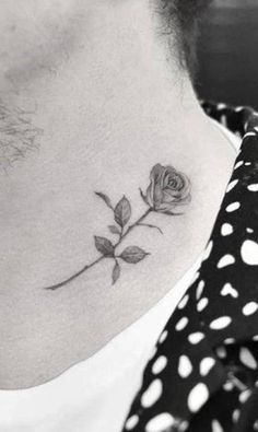 a woman's neck with a rose tattoo on her left side ribcage