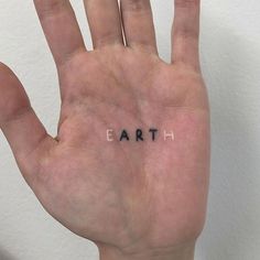 a hand with the word earth written on it