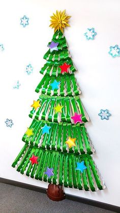 a christmas tree made out of green plastic bottles