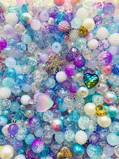 many different colored beads are piled together