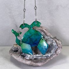 A fascinating piece that captivates you with its colors. This unique coloring pattern is created using Resin Alcohol Inks, which makes each piece unique. Check out my video. 1 3/4 x 1 3/8 Dimensions: ☆ Handmade Whale necklace designed from Solid Copper. Whale Pendant is 1 3/4 inches wide and 1 3/8 inches tall. The Stainless Steel Cable Chain links are 3.2mm wide with Stainless Steel Twisted Bar Connectors. The chain length can be customized. ☆ Handmade Diamond Shaped dangle earrings designed from Solid Copper. Diamond Shape Pendants are 5/8 inches wide and 1 inches tall, and the total drop length is 2 3/8 inches including the Stainless Steel Twisted Bar Connectors and Stainless Steel ear wires. How it's Made: ☆ Copper pendants are hand-cut from a solid copper sheet using a German style jew Artistic Nickel-free Resin Jewelry, Drop Necklaces With Matching Earrings For Gift, Drop Necklaces With Matching Earrings As Gift, Gift Drop Necklaces With Matching Earrings, Gift Drop Necklace With Matching Earrings, Hand Painted Turquoise Drop Earrings, Artistic Resin Dangle Jewelry, Blue Fusion Pendant Jewelry, Handmade Blue-green Necklaces For Gifts