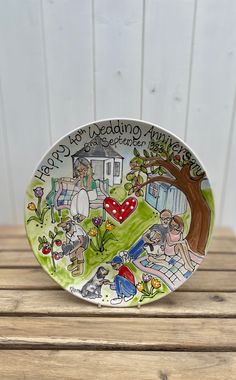 a plate with an image of people and animals on it sitting on a wooden table