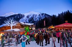 a crowd of people standing around each other in the snow