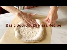 a person is kneading dough on top of a pizza stone with the words basic sourdough pizza recipe