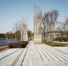 the walkway is lined with metal poles and trees