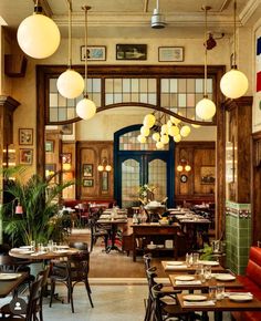 the interior of a restaurant with tables and chairs