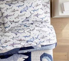 a bed with shark themed sheets and pillows