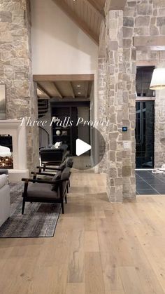 a living room filled with furniture and stone walls