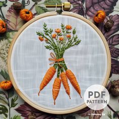 an embroidery project with carrots and flowers on it