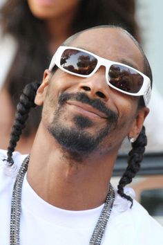 a man with long braids wearing sunglasses