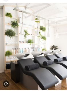 a row of black benches sitting next to each other on top of a hard wood floor