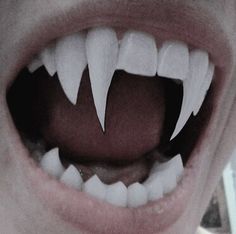 an open mouth with white teeth and no teeth