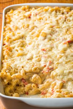 macaroni and cheese casserole in a white dish on a wooden table