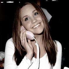 a woman smiles as she talks on the phone