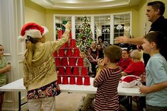 a group of people standing around a christmas tree