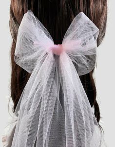 Perfectly pink! A sweet alternative to the wedding veil, the tulle bow! These romantic tulle bows add just a little wedding tradition to your ensemble without all the fuss of the full veil. Cute, a little glam, and very modern! The bows are handmade to order and cut from the softest tulle, they attach with an organza-wrapped metal comb.  The purchase of this listing is for one tulle hair bow:  Style: Tulle veil bow Measurements from top of comb - 15" - Bow measures 5" wide Attachment: 4" x 1.5" Bridal Hair Ribbon, Full Veil, Hair Bow Style, Headpiece Veil, Veil Bow, Tulle Hair Bow, Veil Alternative, Black Hair Comb, Bridal Bow