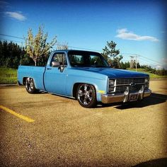 a blue pickup truck parked in a parking lot