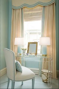 a bedroom with blue walls and white furniture