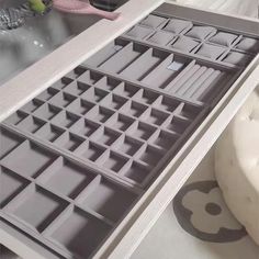 an open drawer is shown in the middle of a counter top with drawers on it